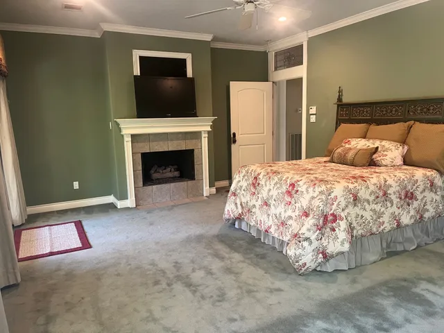 a bedroom with a bed and a fireplace