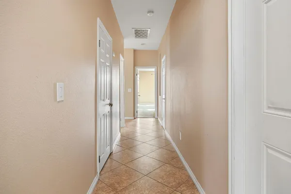 an empty room with a window and a ceiling fan