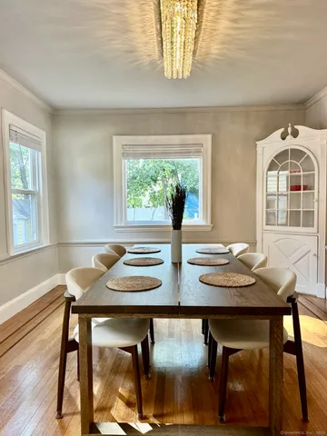 a view of a dining room with furniture and a window