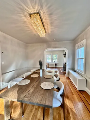 a dining room with furniture and wooden floor