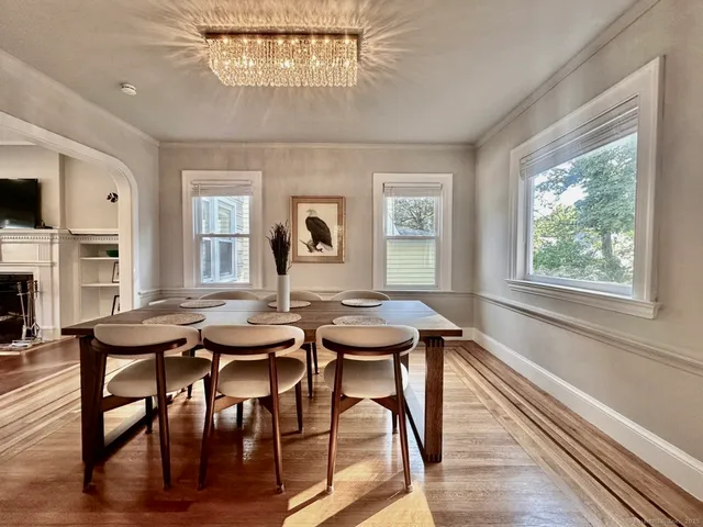 a view of a dining room with furniture window and wooden floor