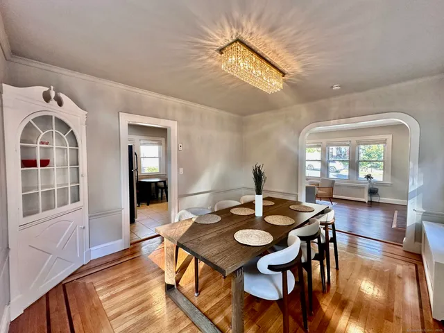 a view of a dining room with furniture and wooden floor