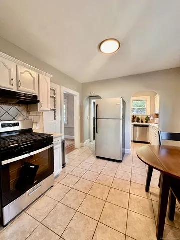 a kitchen with a cabinets and a stove top oven