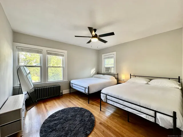 a bedroom with a bed couch and a window