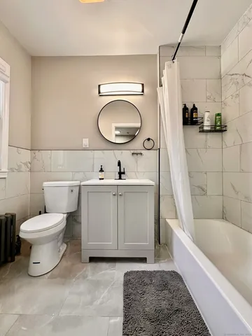 a bathroom with a toilet a sink and bathtub