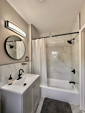 a bathroom with a sink a mirror and a bathtub