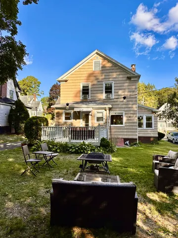 a view of a house with backyard porch and sitting area