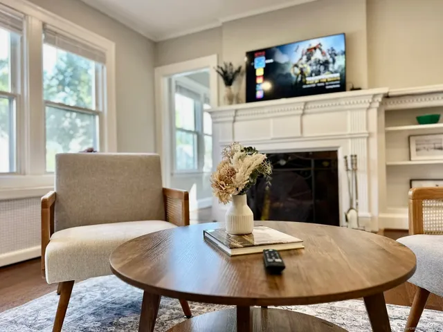 a living room with furniture and a fireplace