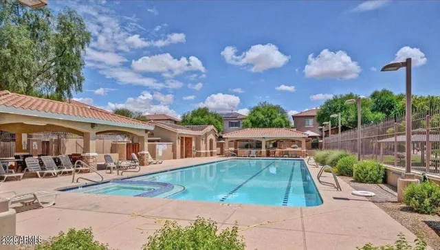 a view of a patio with couches table and chairs and potted plants