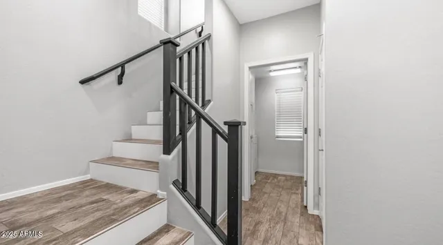 a view of entryway and hall with wooden floor