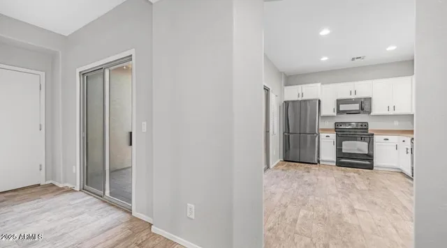 a kitchen with stainless steel appliances a refrigerator and a stove top oven