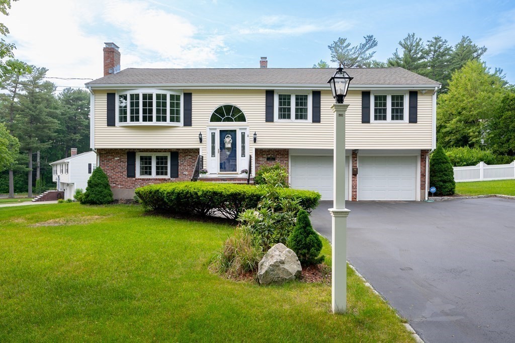 21 Harvest Lane Hingham, MA 02043 - Photo 1 of 35 a front view of a house with a yard and trees
