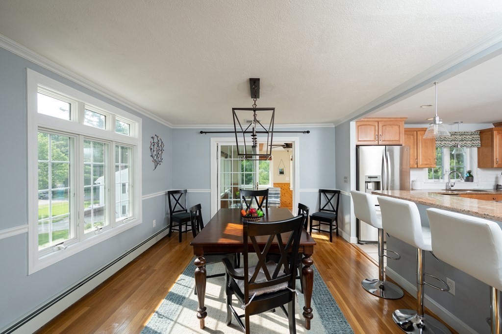 21 Harvest Lane Hingham, MA 02043 - Photo 11 of 35 a dining room with furniture a chandelier and wooden floor