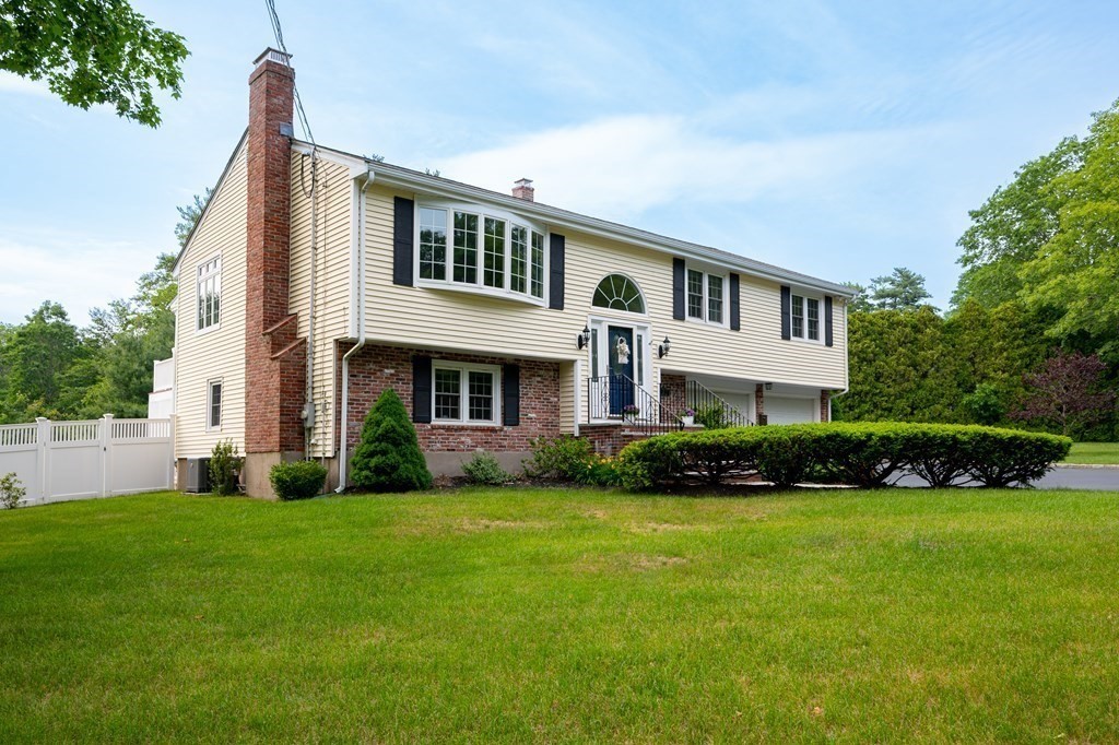 21 Harvest Lane Hingham, MA 02043 - Photo 2 of 35 a front view of a house with a garden