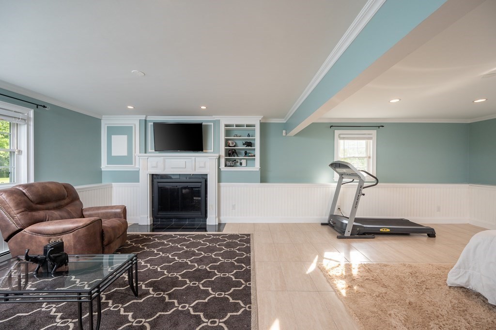21 Harvest Lane Hingham, MA 02043 - Photo 24 of 35 a living room with furniture a fireplace and a flat screen tv