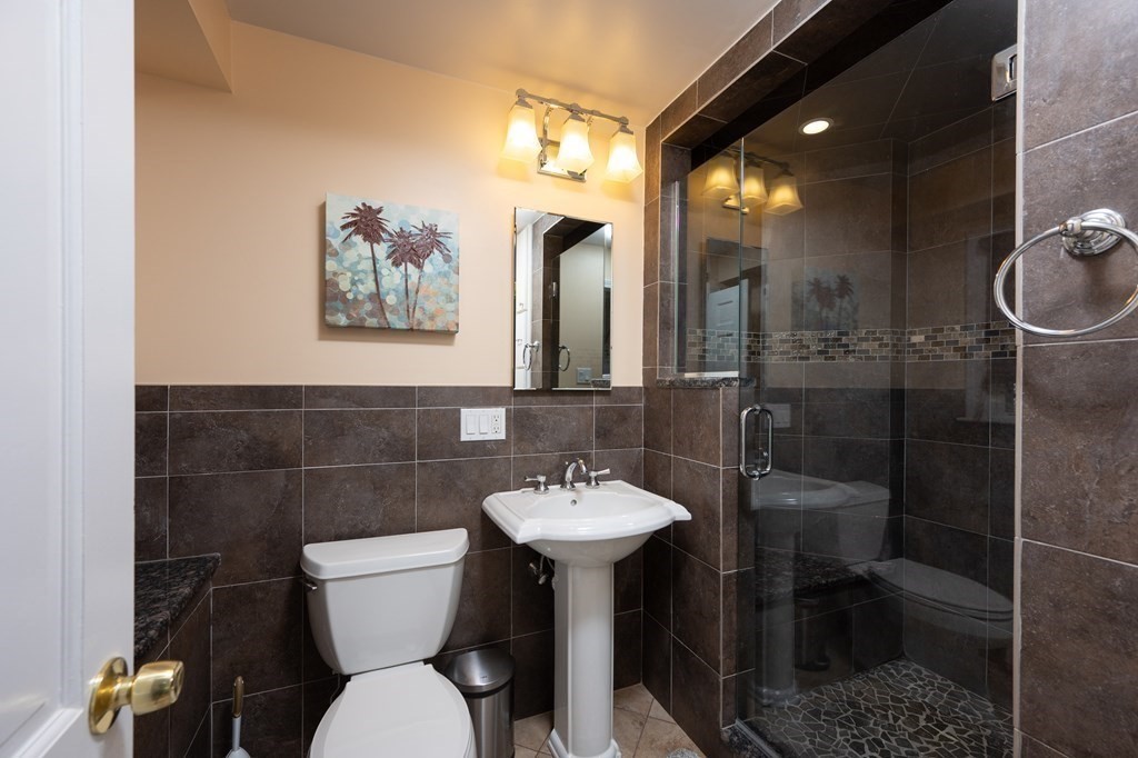 21 Harvest Lane Hingham, MA 02043 - Photo 26 of 35 a bathroom with a toilet a sink and mirror