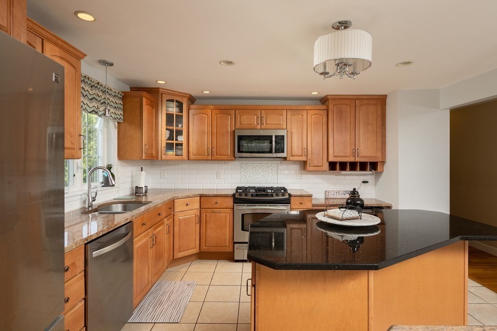 21 Harvest Lane Hingham, MA 02043 - Photo 4 of 35 a kitchen with a sink a stove and cabinets