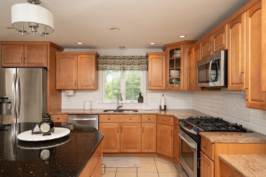 21 Harvest Lane Hingham, MA 02043 - Photo 6 of 35 a kitchen with stainless steel appliances a sink a stove a refrigerator and cabinets