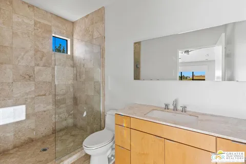a view of a patio with a table and chairs under an umbrella