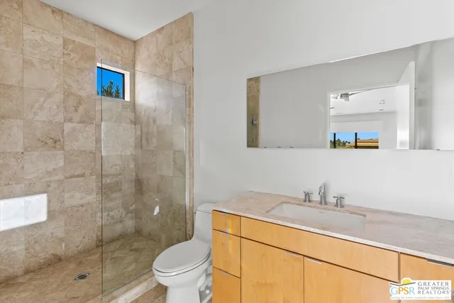 a view of a patio with a table and chairs under an umbrella