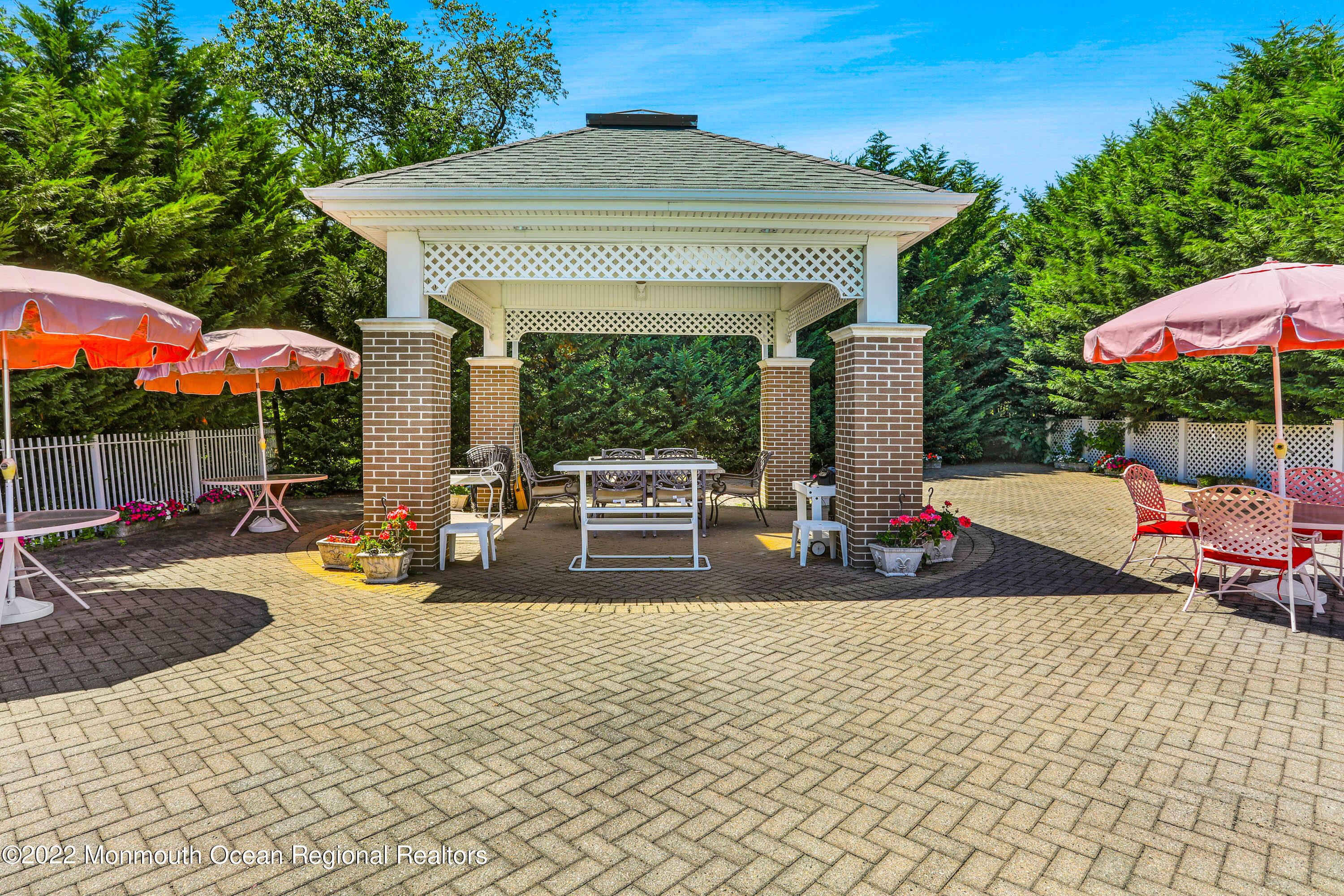 1903 Shadowbrook Drive Wall, NJ 07719 - Photo 11 of 74 a view of a patio with table and chairs under an umbrella