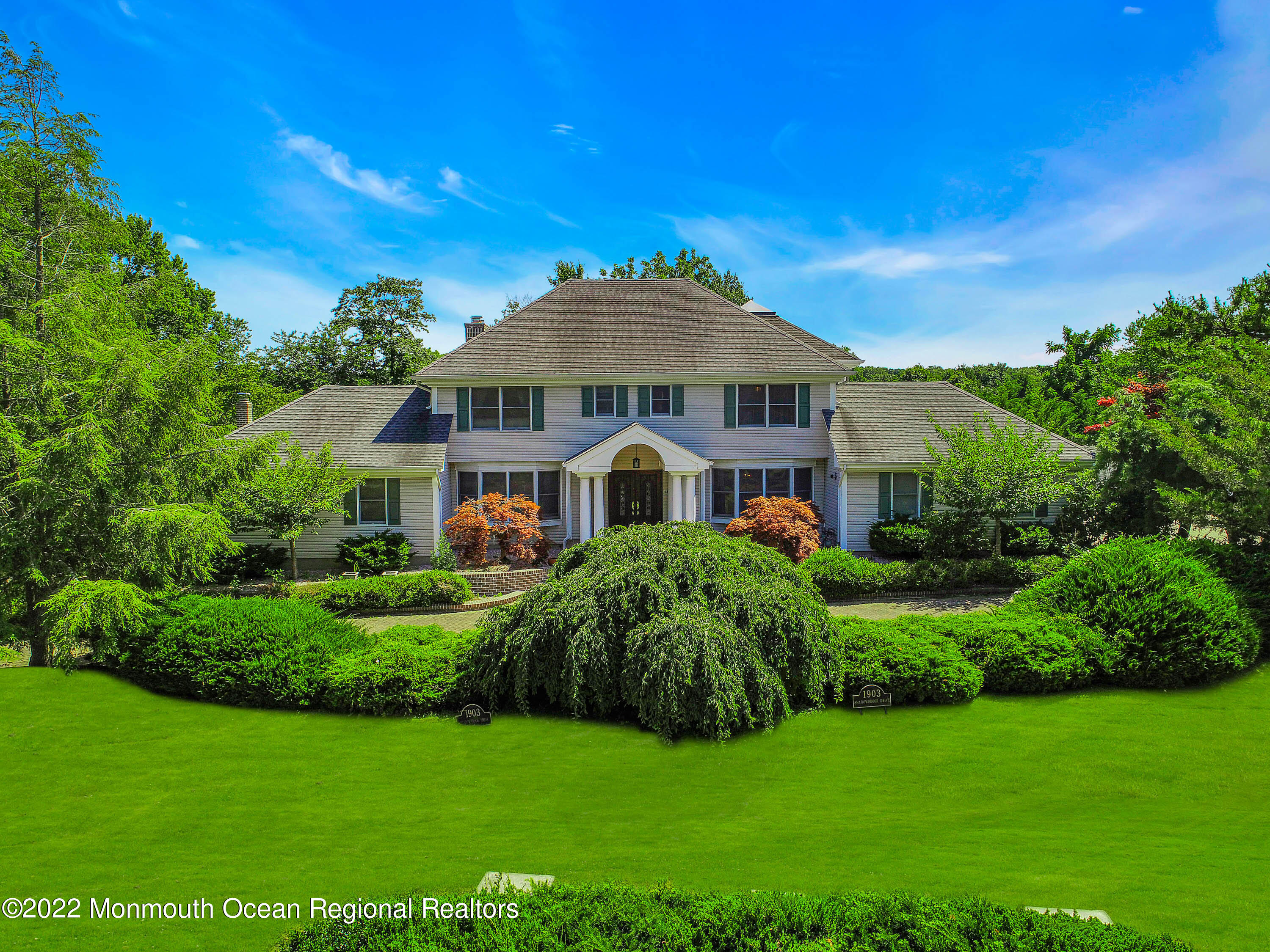 1903 Shadowbrook Drive Wall, NJ 07719 - Photo 13 of 74 a front view of a house with a garden