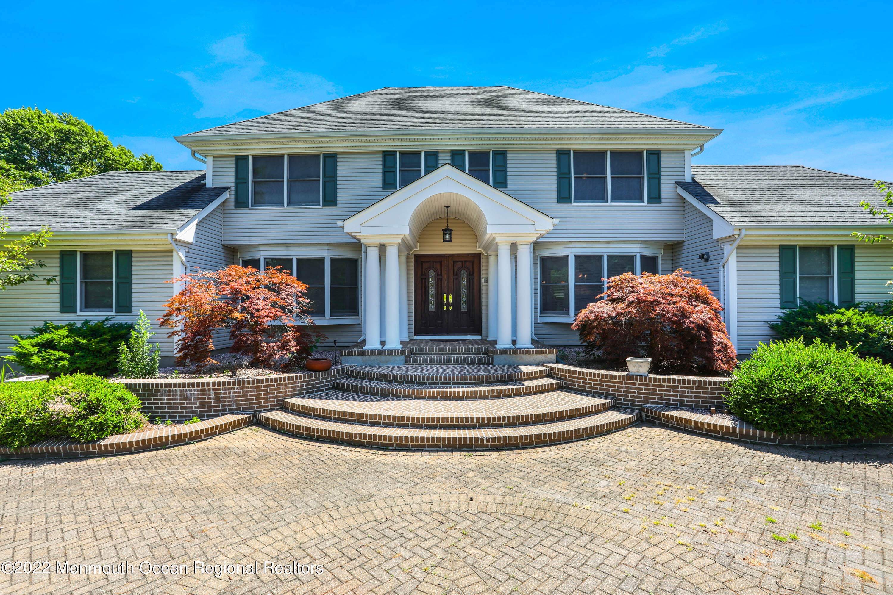 1903 Shadowbrook Drive Wall, NJ 07719 - Photo 14 of 74 a front view of a house with garden