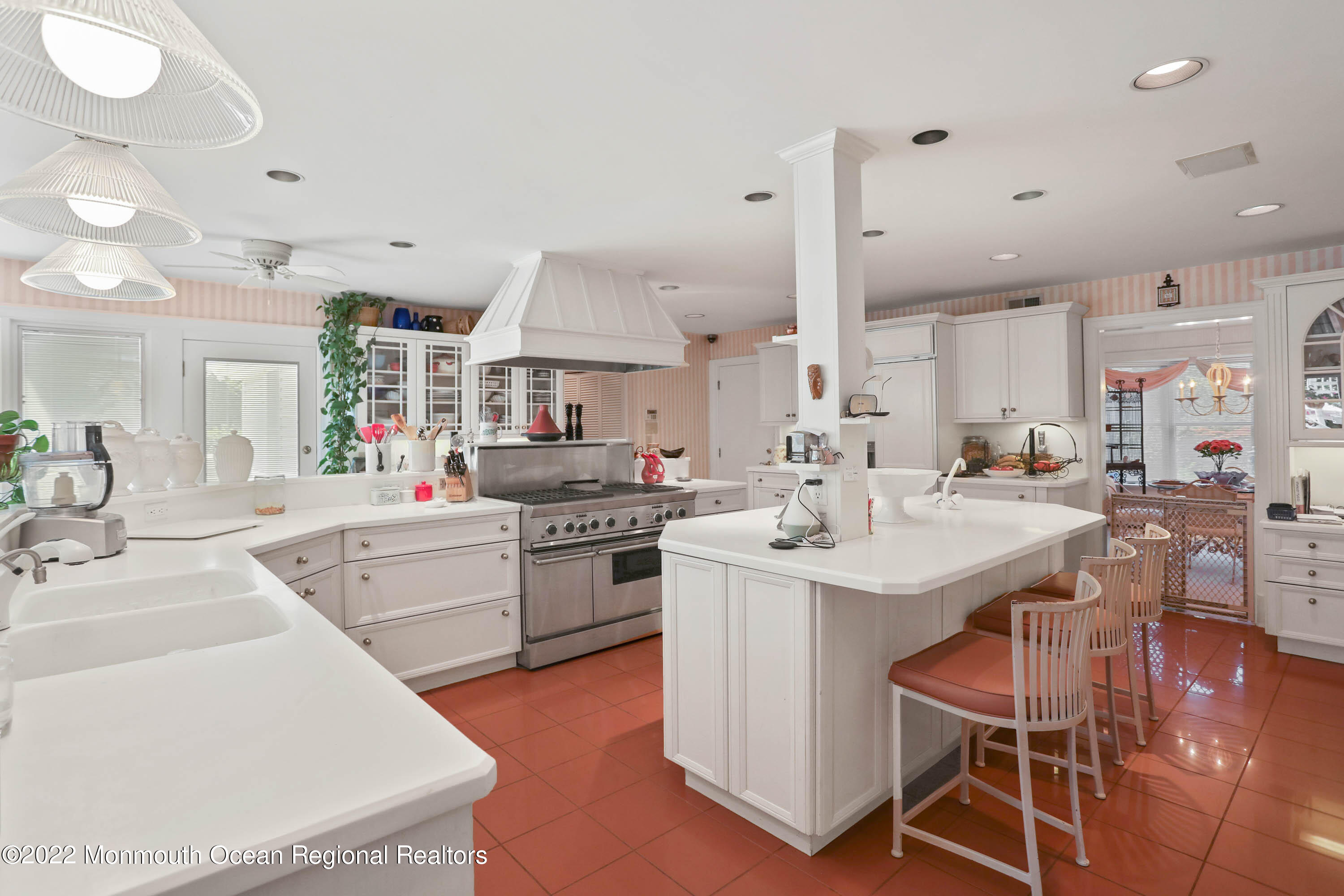1903 Shadowbrook Drive Wall, NJ 07719 - Photo 26 of 74 a kitchen with stainless steel appliances kitchen island granite countertop a sink stove and white cabinets with wooden floor