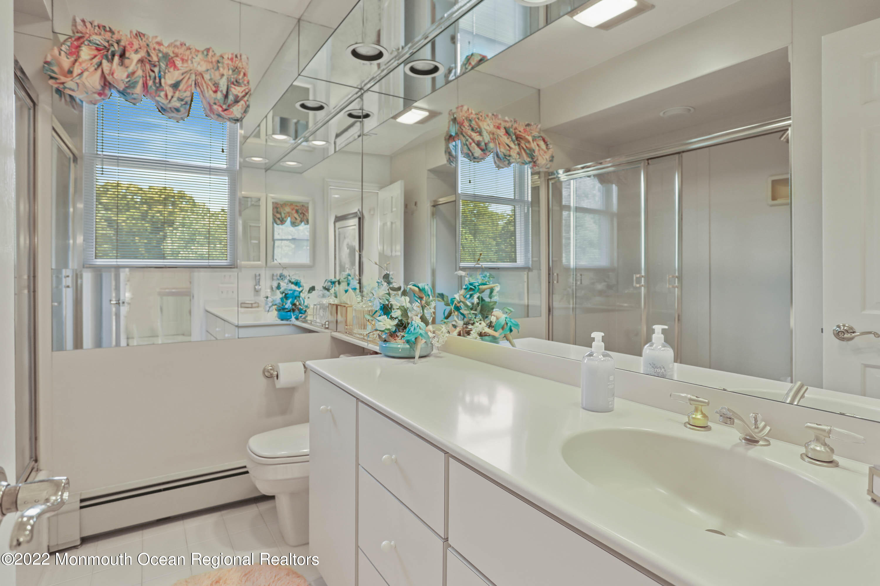 1903 Shadowbrook Drive Wall, NJ 07719 - Photo 46 of 74 a bathroom with a sink a large mirror and a bathtub