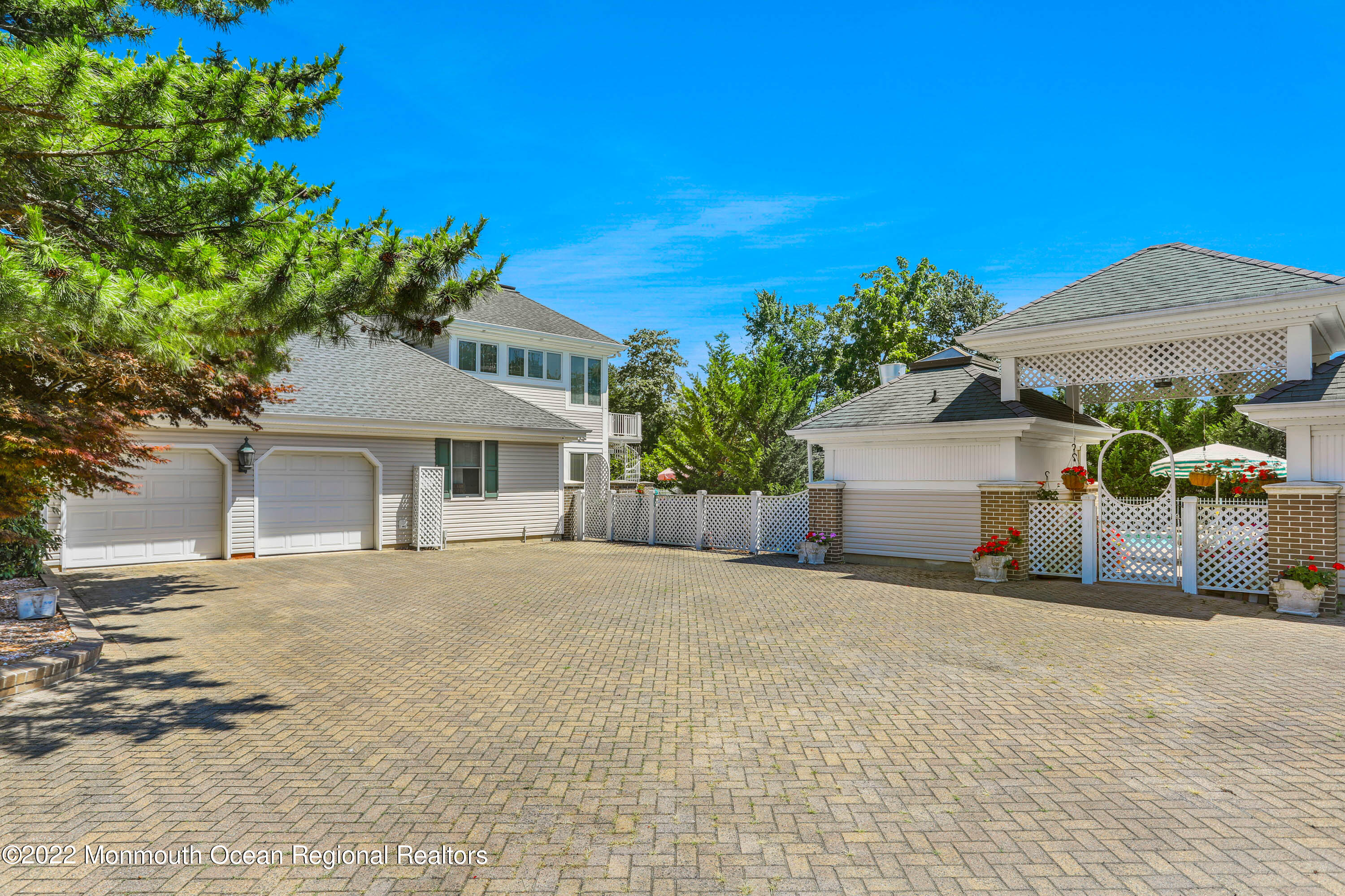 1903 Shadowbrook Drive Wall, NJ 07719 - Photo 71 of 74 a front view of a house with a yard and garage