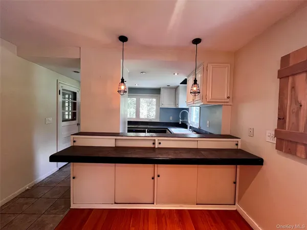 a kitchen with stainless steel appliances granite countertop a sink a stove and a wooden floors