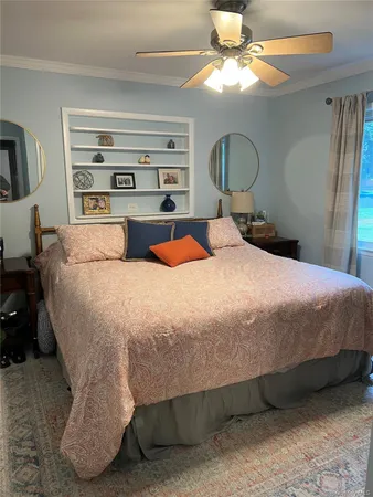 a bedroom with a bed and dresser with mirror
