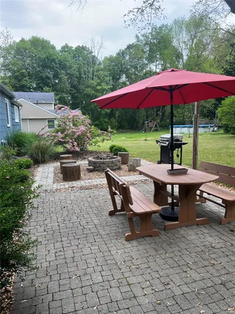 a view of a patio with table and chairs under an umbrella