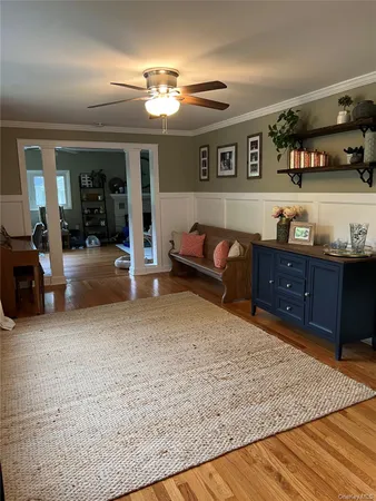 a living room with furniture and chandelier