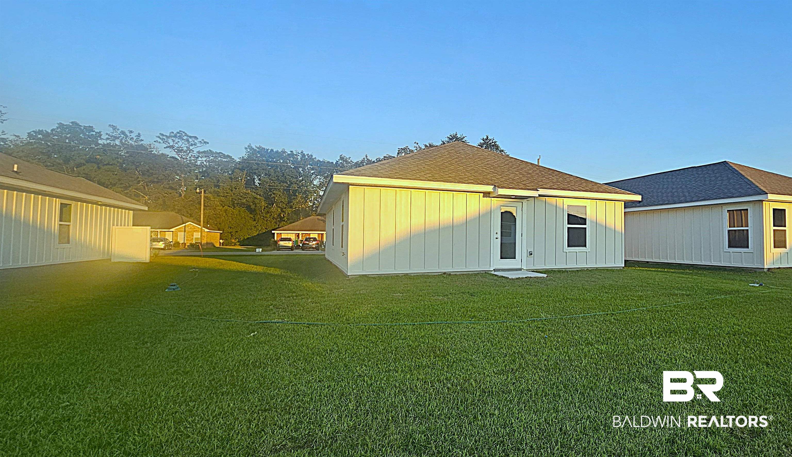1084 South Bay Street Foley, AL 36535 - Photo 6 of 31 Back of house featuring a yard