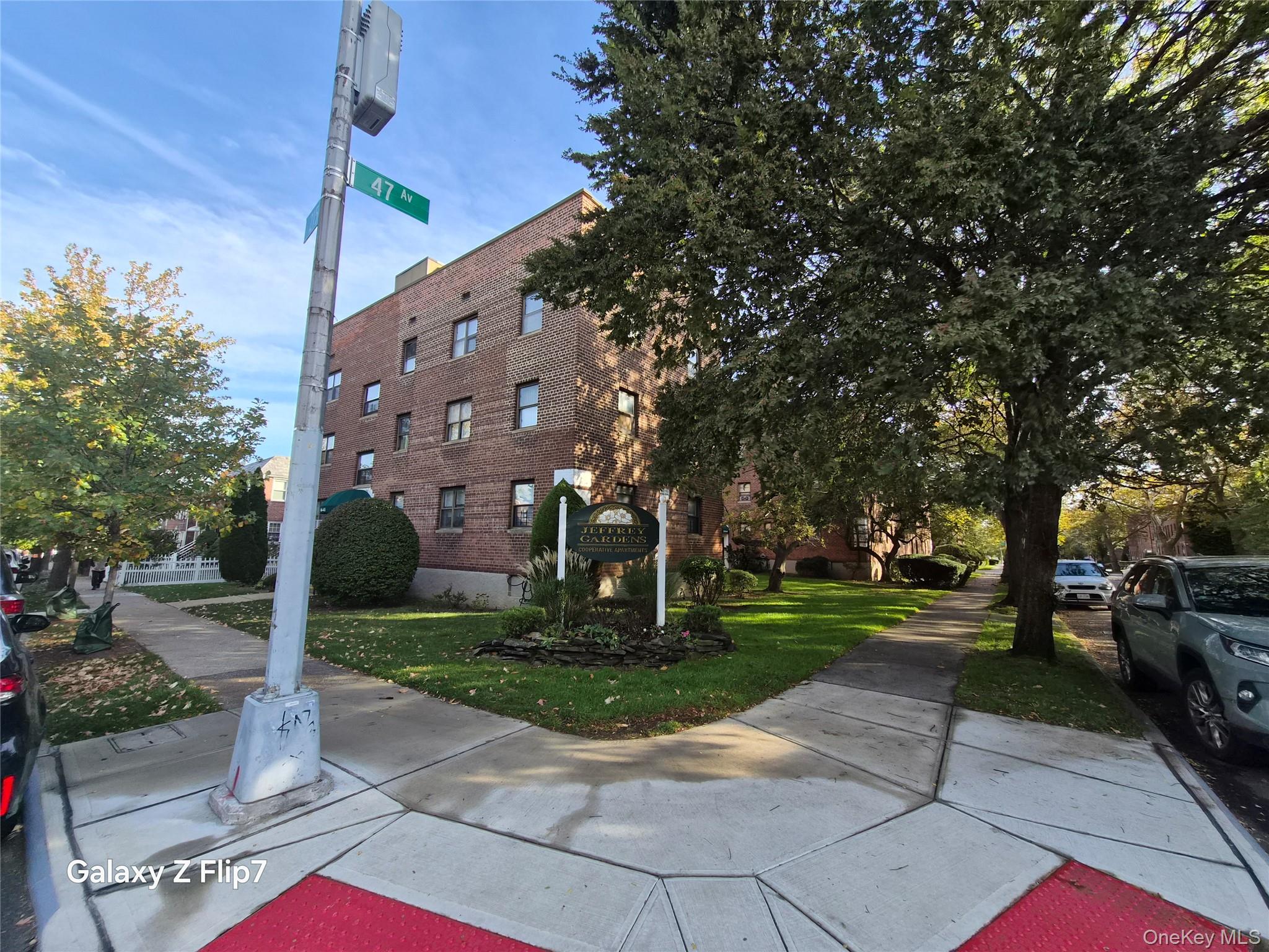215-09 47th Avenue, Unit 2C Queens, NY 11361 - Photo 1 of 10 a view of a building with a yard