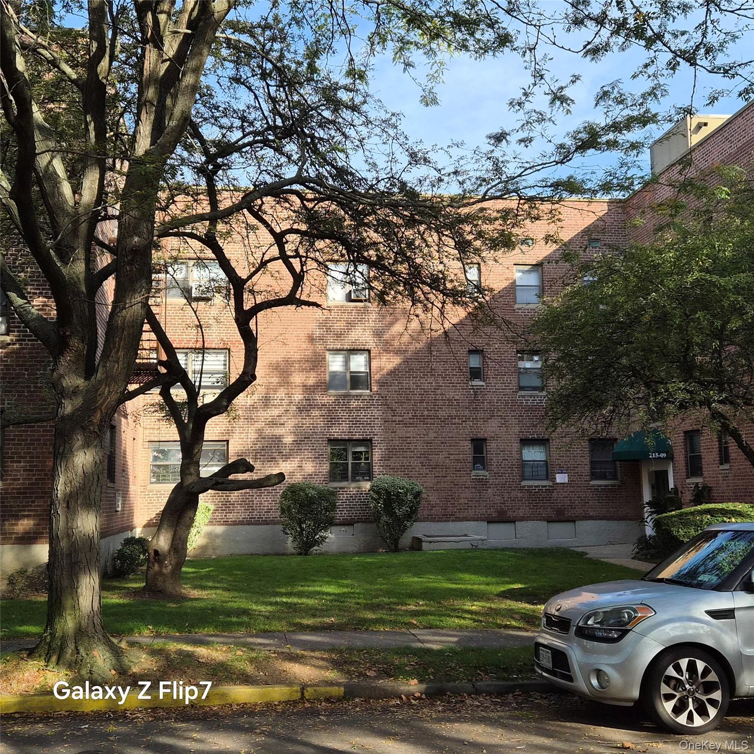 215-09 47th Avenue, Unit 2C Queens, NY 11361 - Photo 2 of 10 a front view of a house with garden