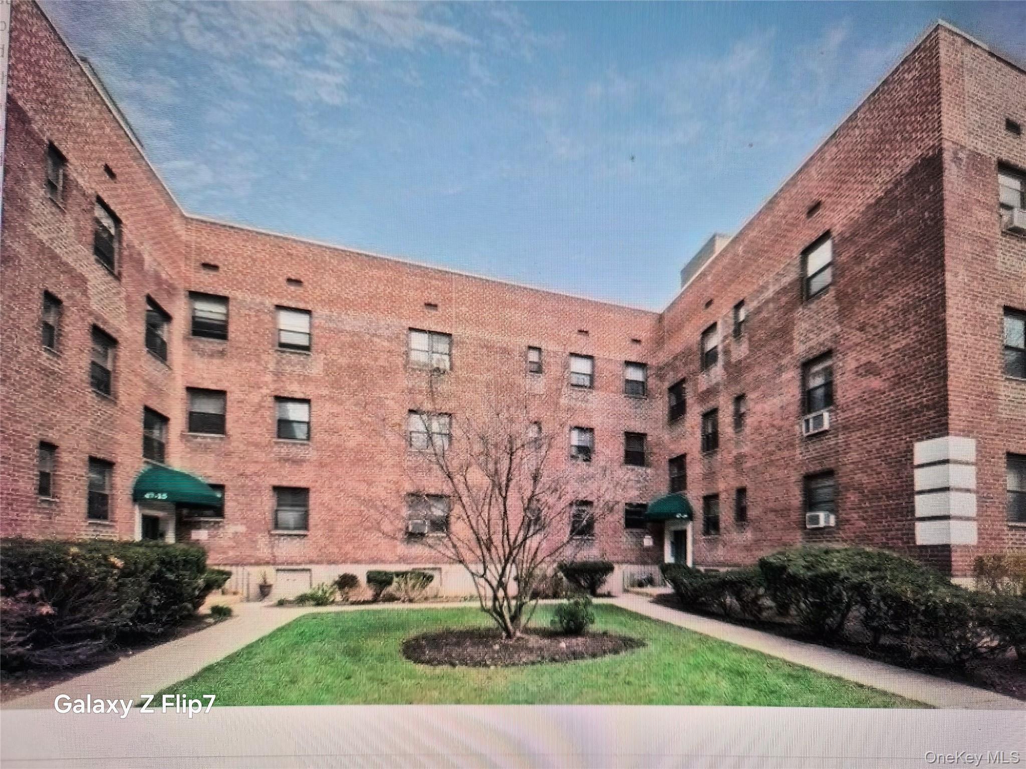 215-09 47th Avenue, Unit 2C Queens, NY 11361 - Photo 3 of 10 a view of a building with a yard