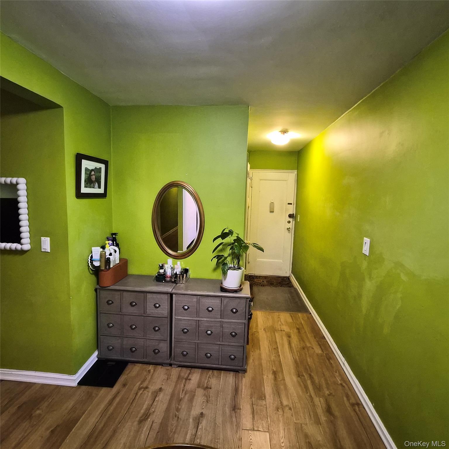 215-09 47th Avenue, Unit 2C Queens, NY 11361 - Photo 5 of 10 a bedroom with a bed and a dresser