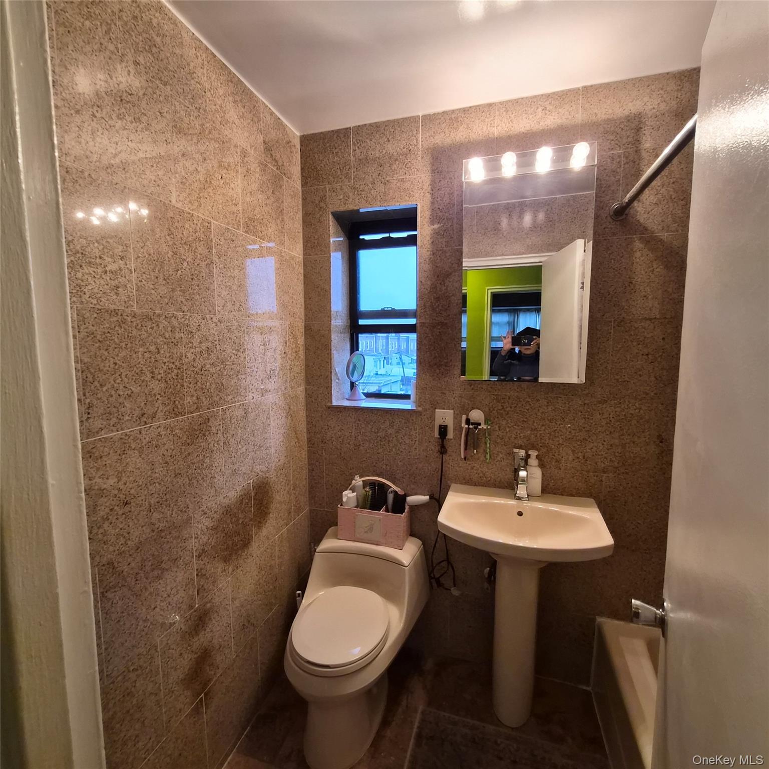 215-09 47th Avenue, Unit 2C Queens, NY 11361 - Photo 10 of 10 a bathroom with a sink toilet and mirror