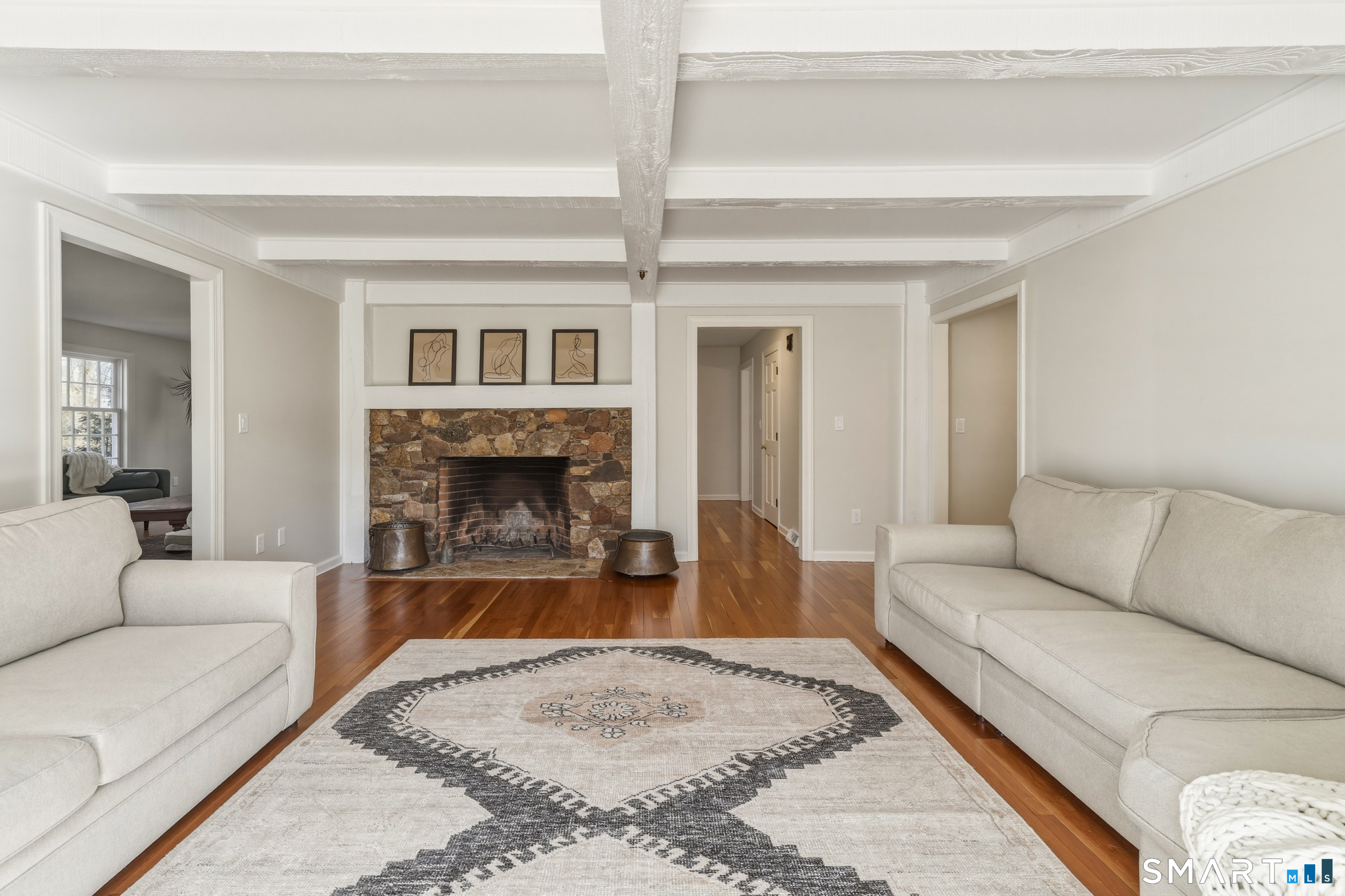 776 Bethany Mountain Road Cheshire, CT 06410 - Photo 12 of 40 a living room with furniture and a fireplace