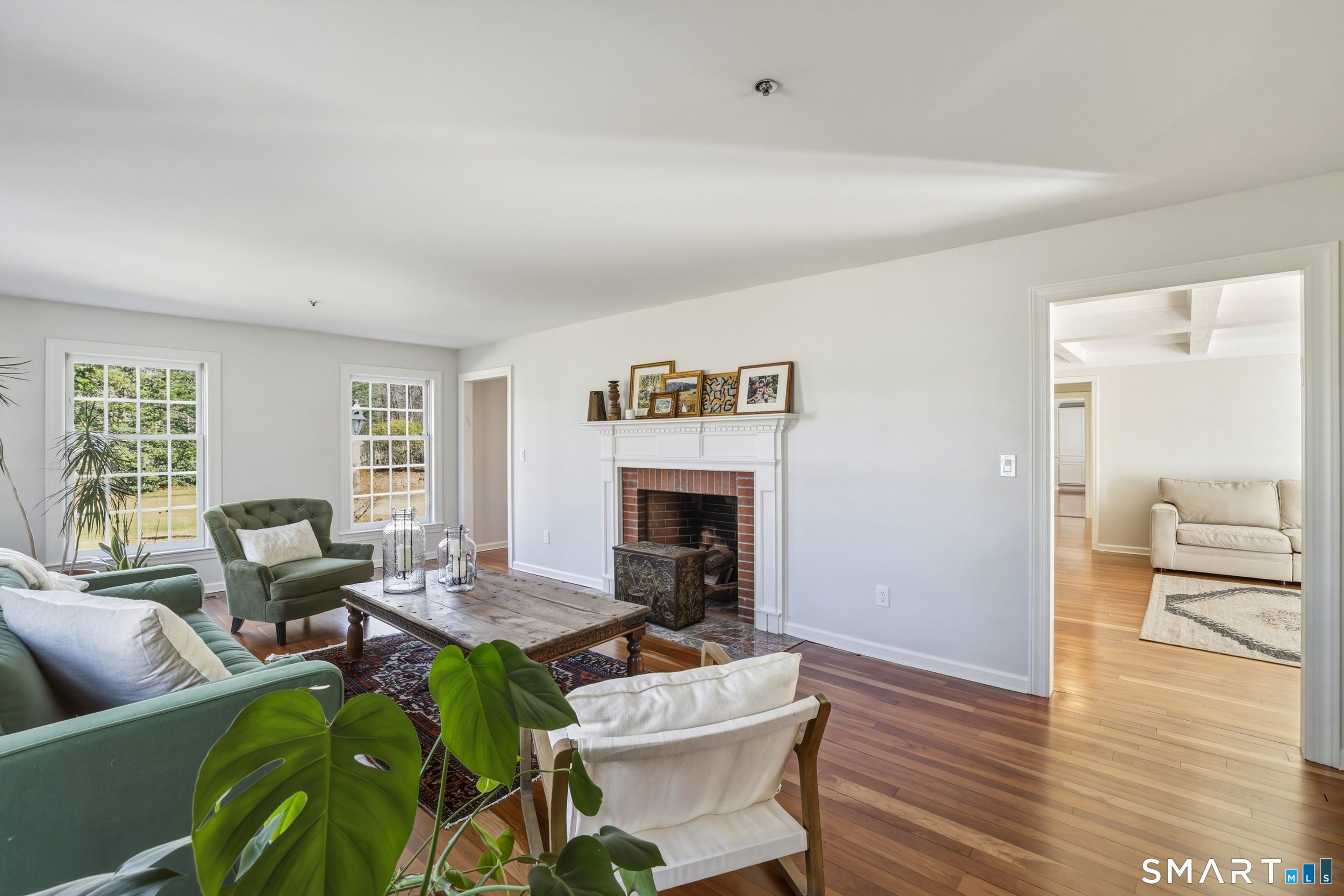 776 Bethany Mountain Road Cheshire, CT 06410 - Photo 14 of 40 a living room with furniture floor to ceiling window and wooden floor