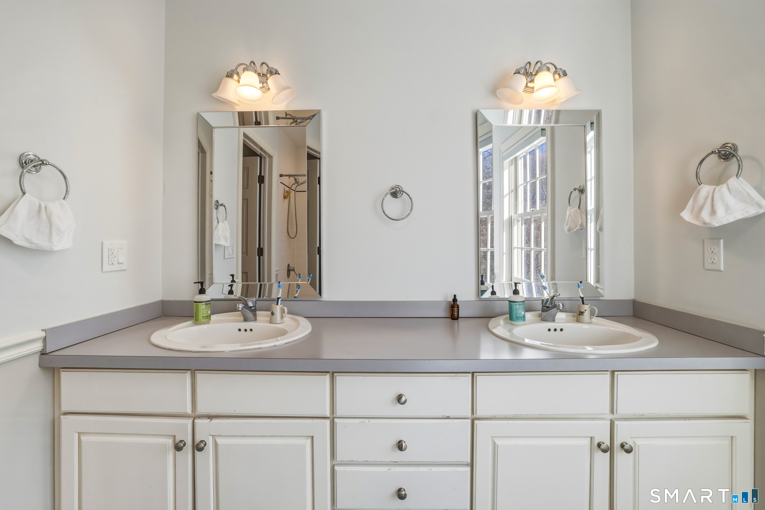 776 Bethany Mountain Road Cheshire, CT 06410 - Photo 25 of 40 a bathroom with a double vanity sink and a mirror