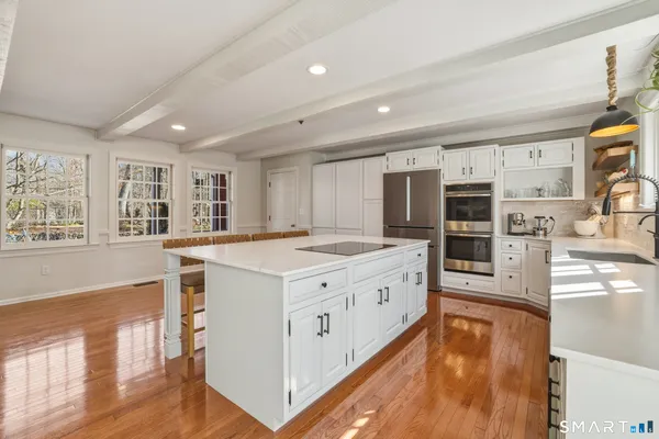 a kitchen with stainless steel appliances granite countertop a stove and a large refrigerator