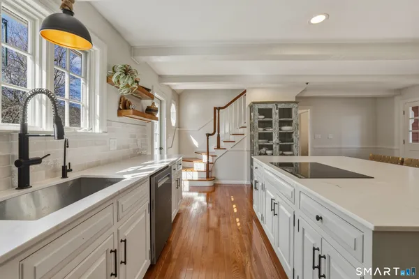 a kitchen with granite countertop a sink and cabinets