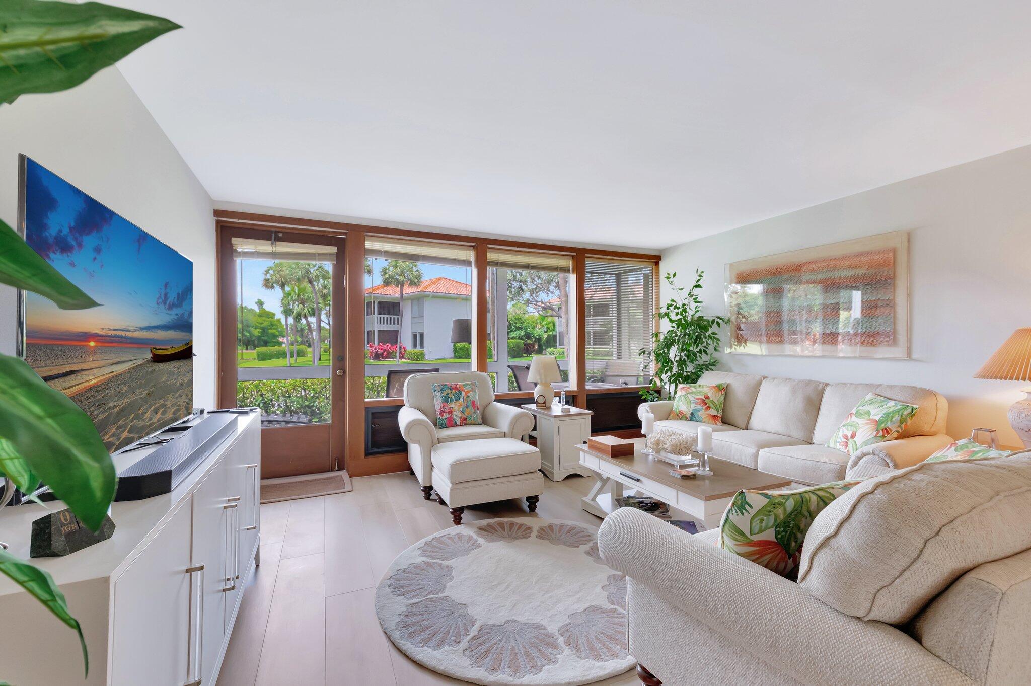 19819 Boca W Drive, Unit 4033 Boca Raton, FL 33434 - Photo 11 of 58 a living room with furniture and a large window