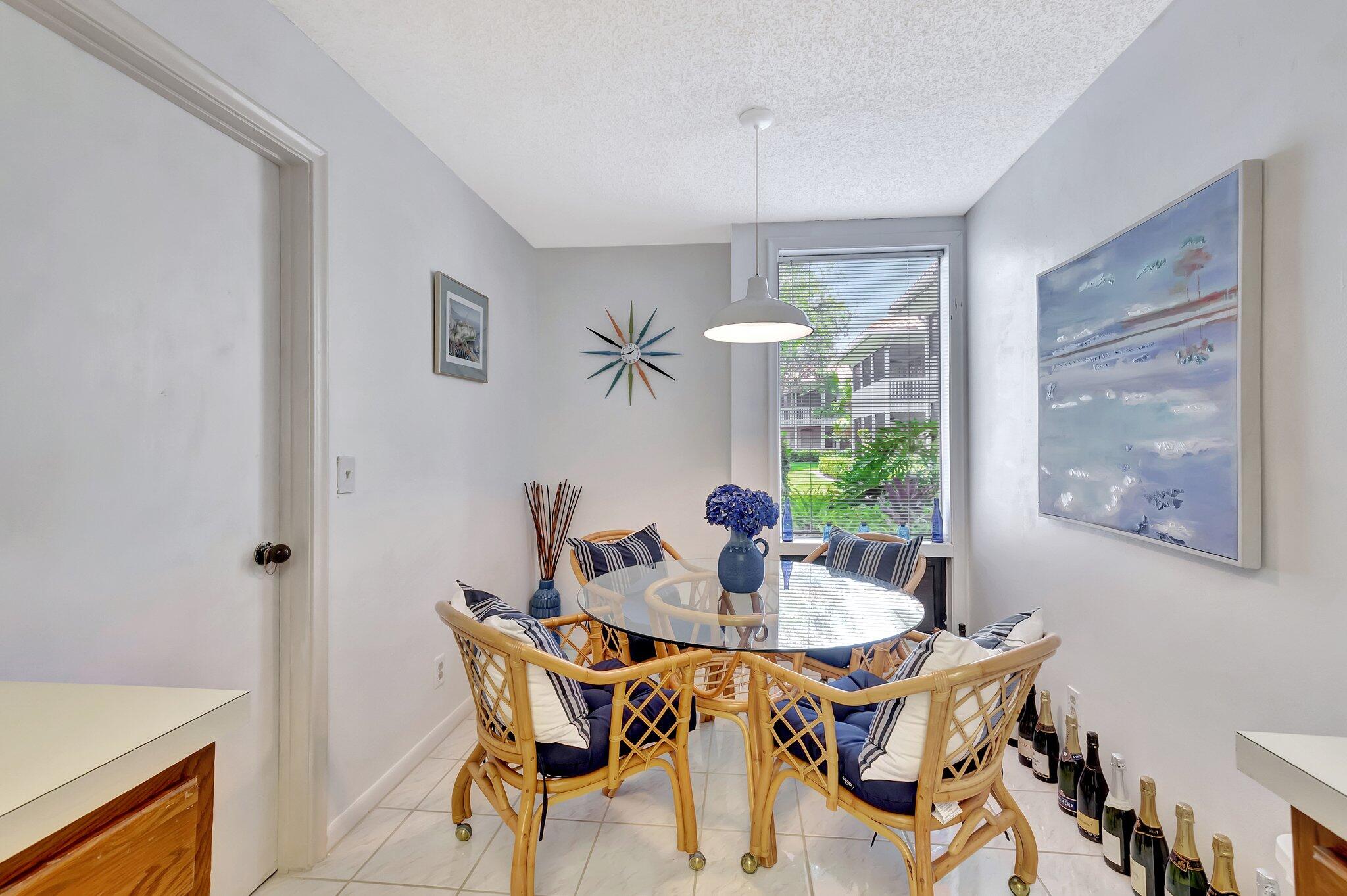 19819 Boca W Drive, Unit 4033 Boca Raton, FL 33434 - Photo 19 of 58 a dining room with furniture a chandelier and window