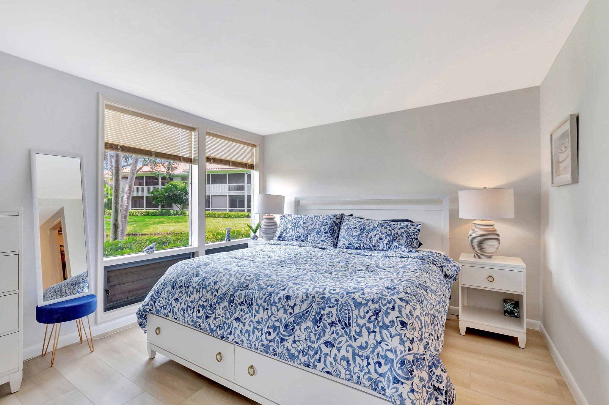 19819 Boca W Drive, Unit 4033 Boca Raton, FL 33434 - Photo 2 of 58 a bedroom with a bed and a large window