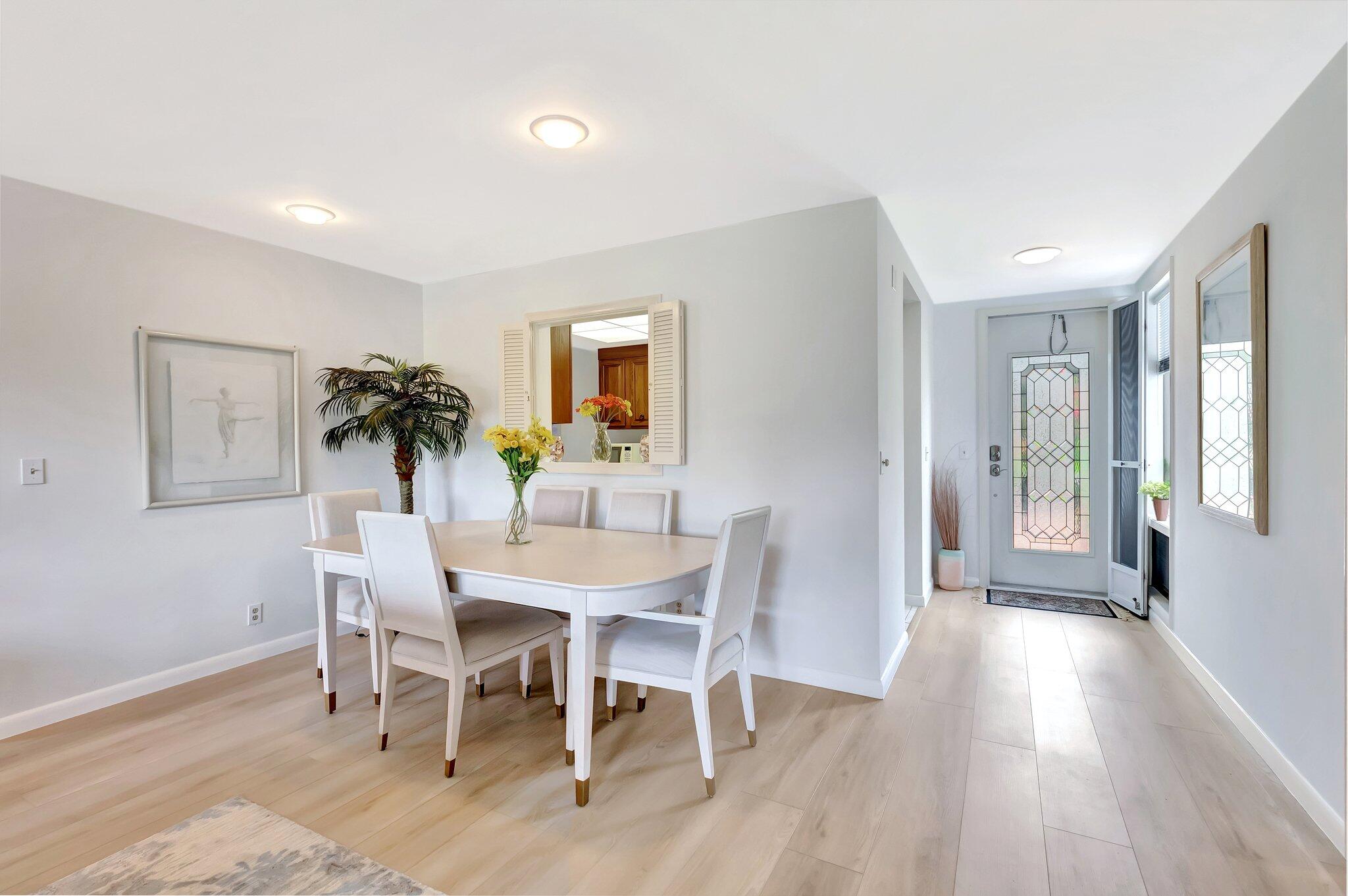 19819 Boca W Drive, Unit 4033 Boca Raton, FL 33434 - Photo 3 of 58 a view of a dining room with furniture and wooden floor