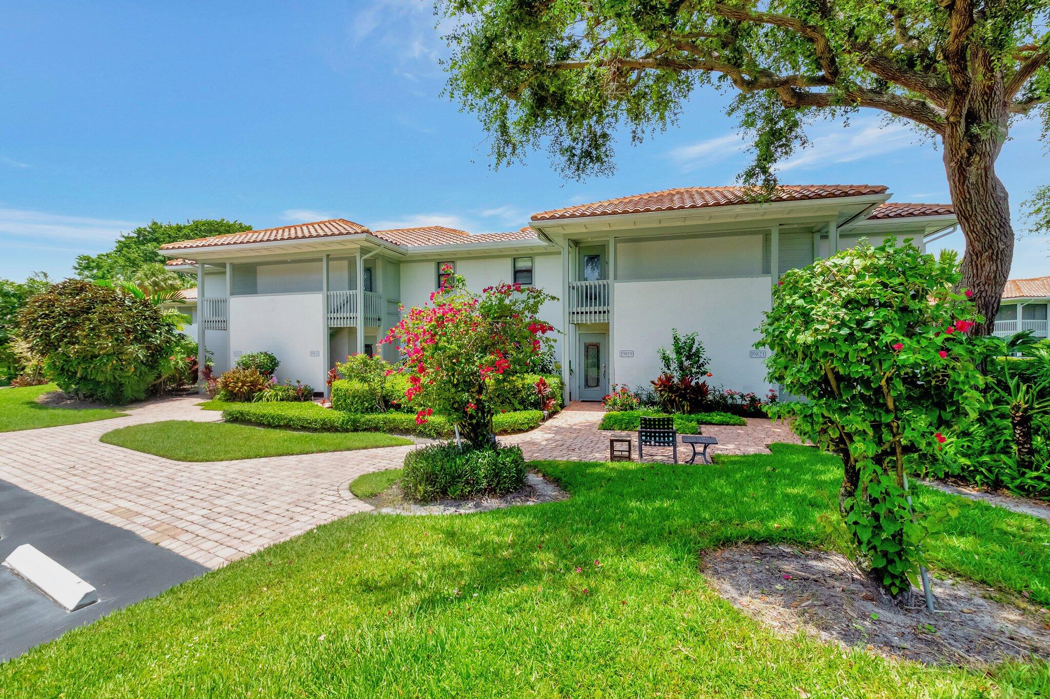 19819 Boca W Drive, Unit 4033 Boca Raton, FL 33434 - Photo 32 of 58 a view of a house with a yard and potted plants